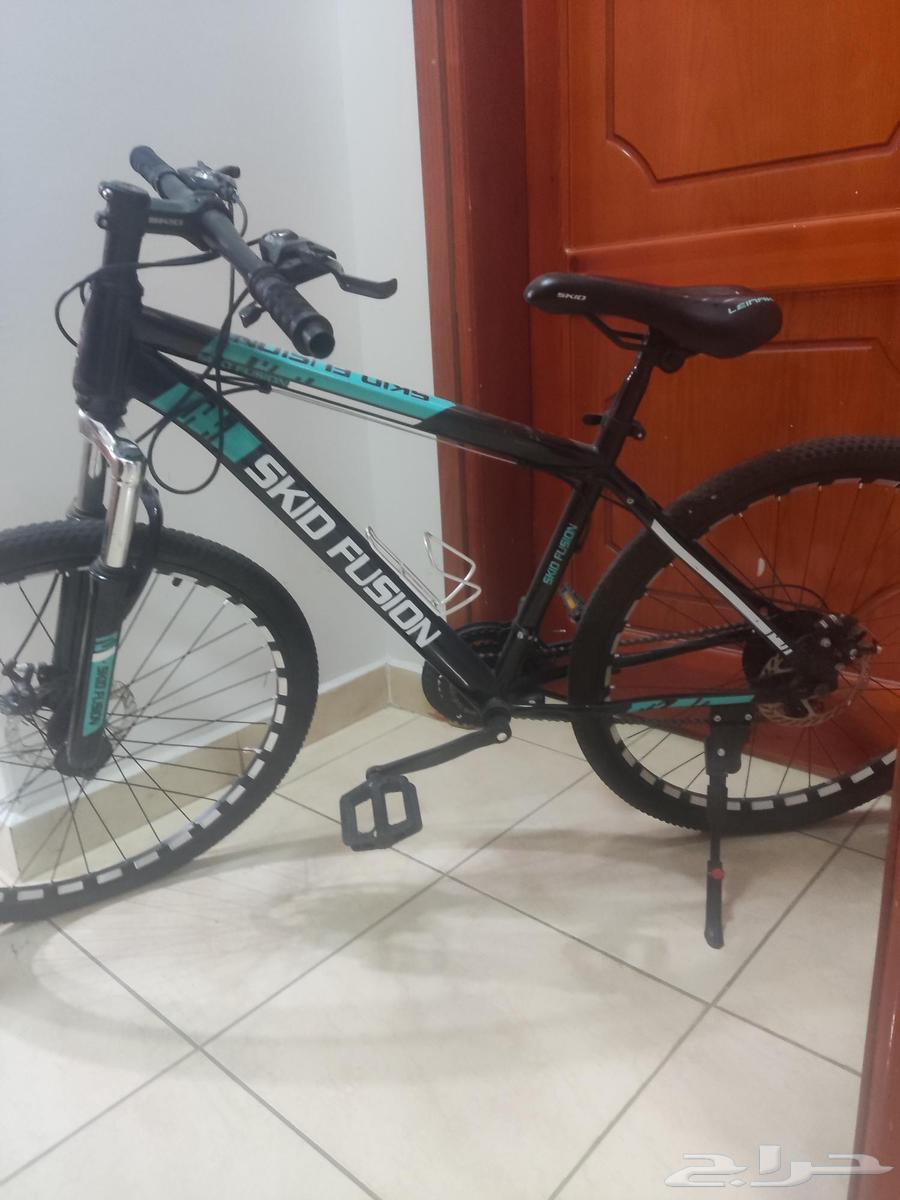 Skid Fusion bicycle in blue and black color with helmet and64575531691138111