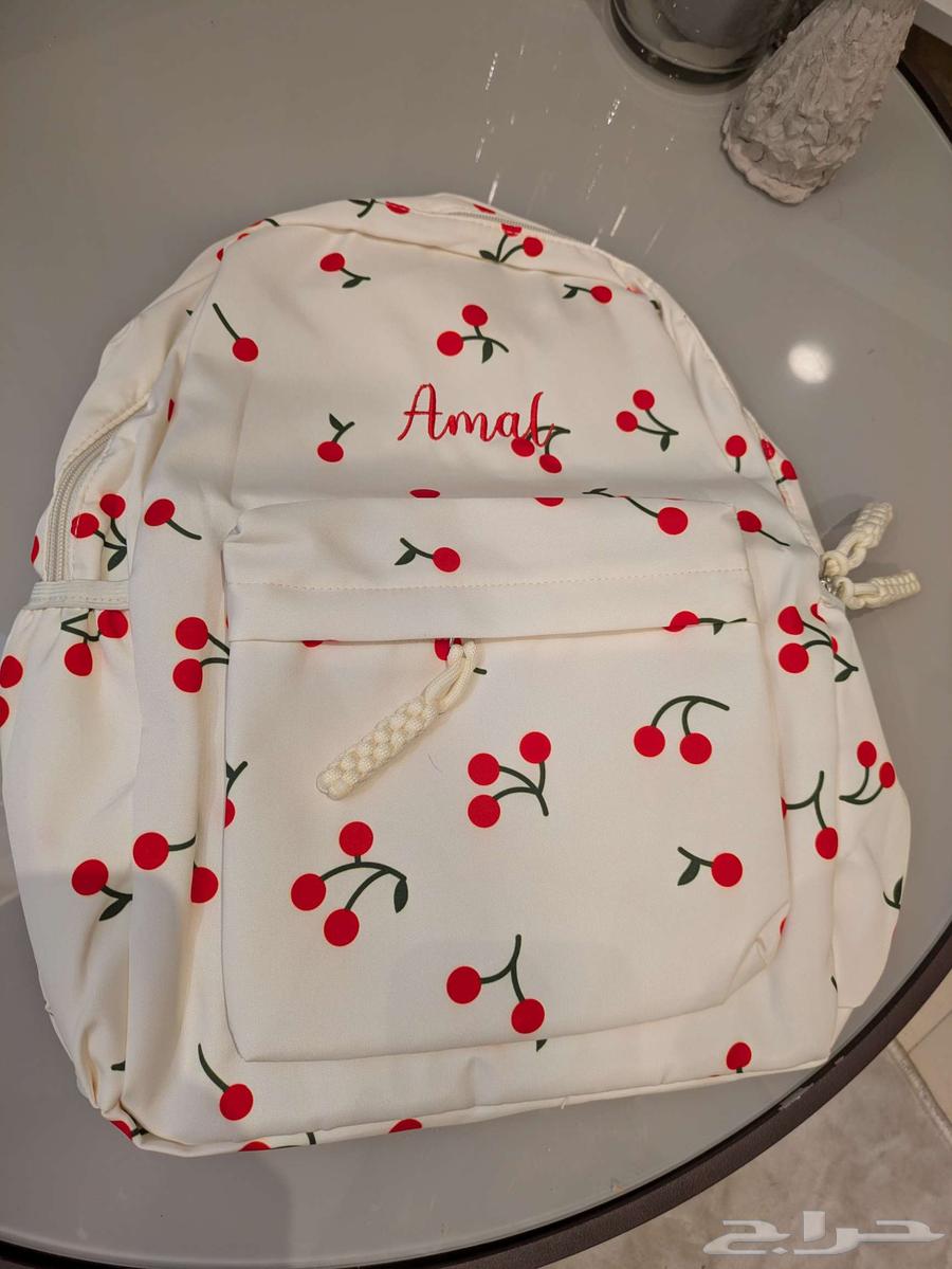 A distinctive new school bag with the name (Amal) written on it64416187929859110