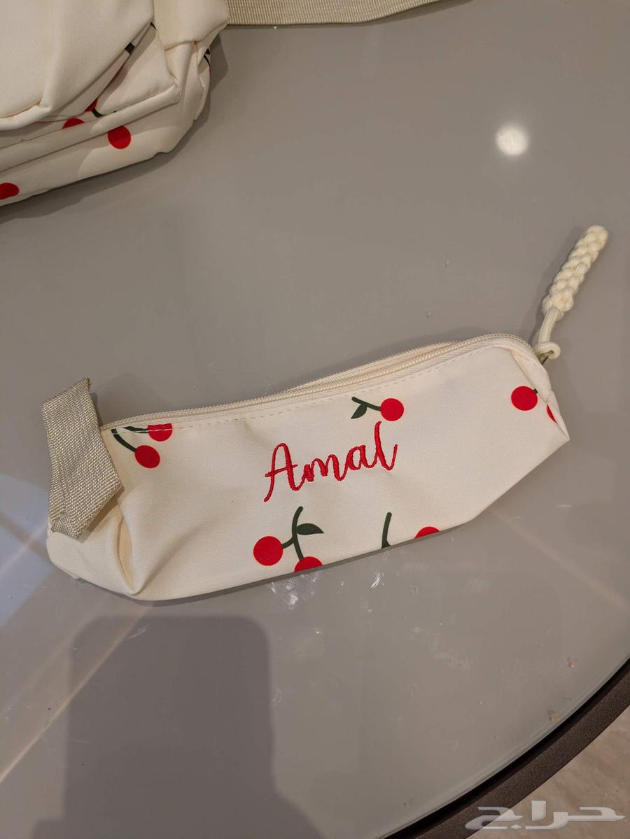 A distinctive new school bag with the name (Amal) written on it64416187929859112