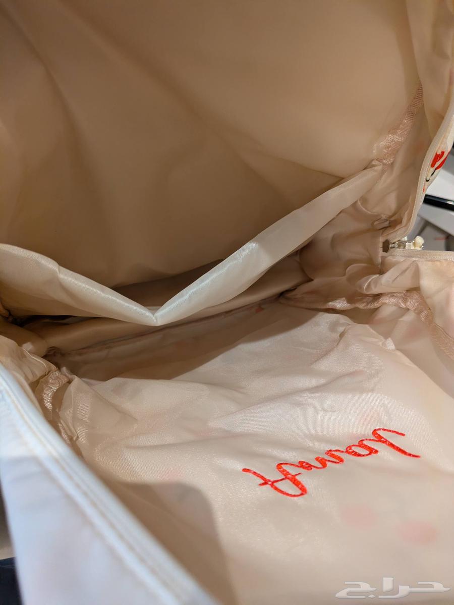 A distinctive new school bag with the name (Amal) written on it64416187929859113